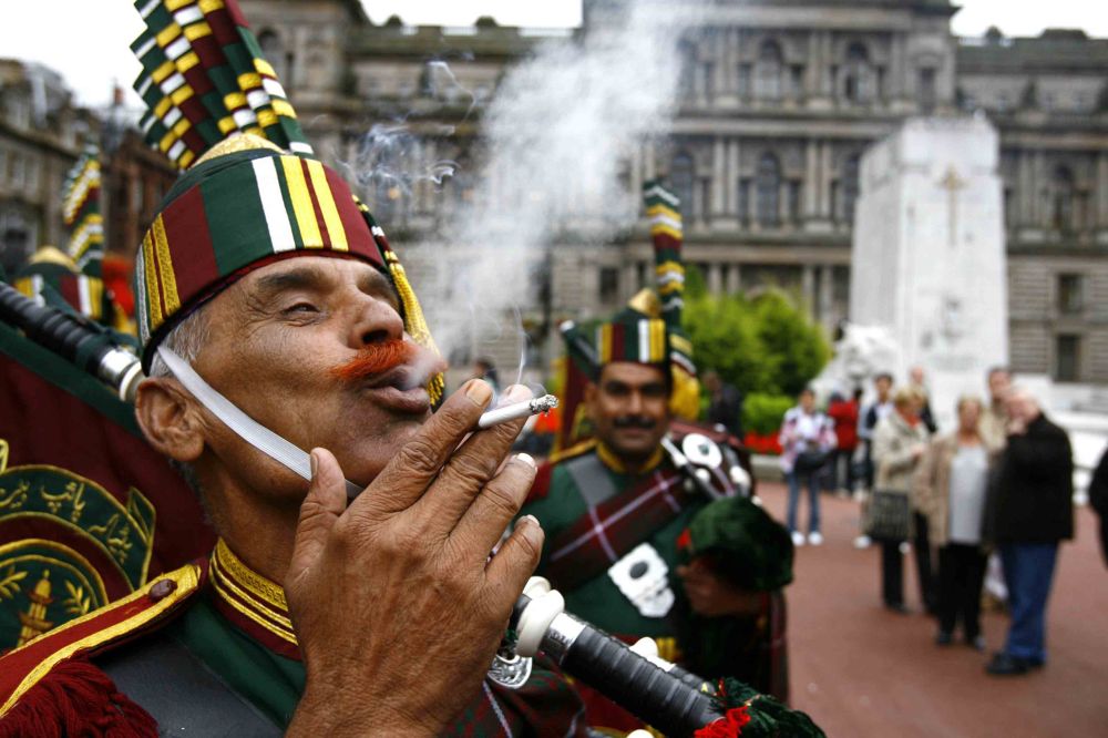 Mohammad Bashir of Patiala Pipe Band enjoys a cigarette in George Square at the launch of Piping Live 